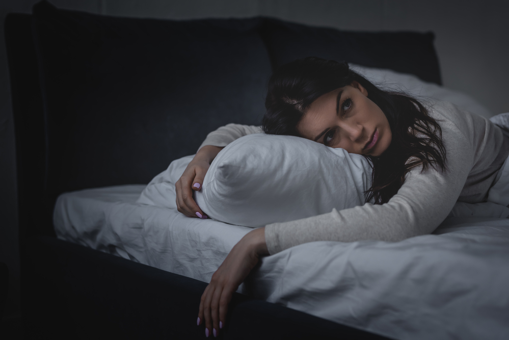 Woman lying in bed awake