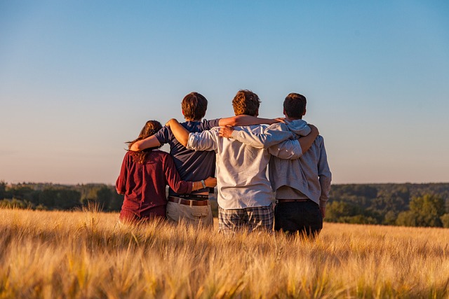 Mental Health Therapy For Teens - group of teenagers sitting together in a field