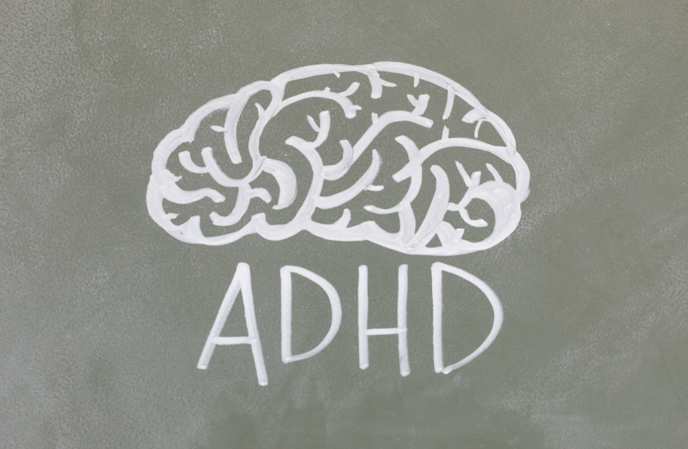 ADHD Diagnosis - brain with ADHD caption painted on a grey wall