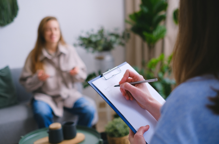 Mental health counselor taking to a woman