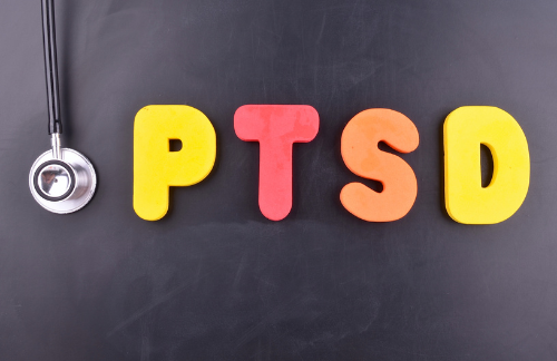 PTSD treatment - colorful sign reading "ptsd" sitting next to a stethoscope